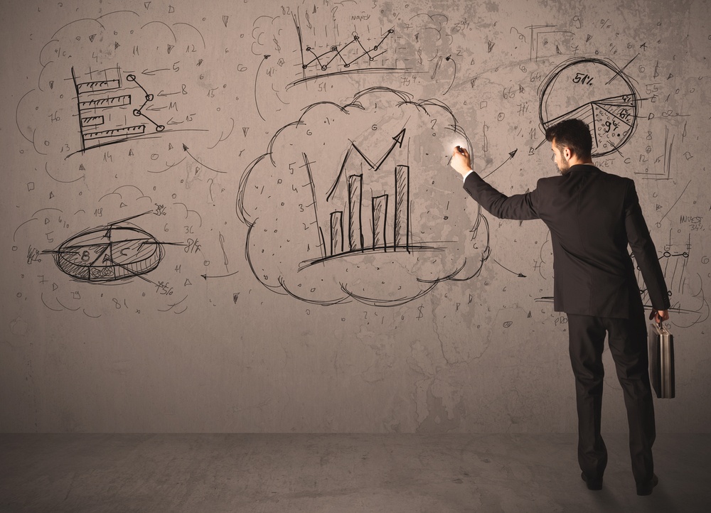 Businessman drawing a business project on a wall